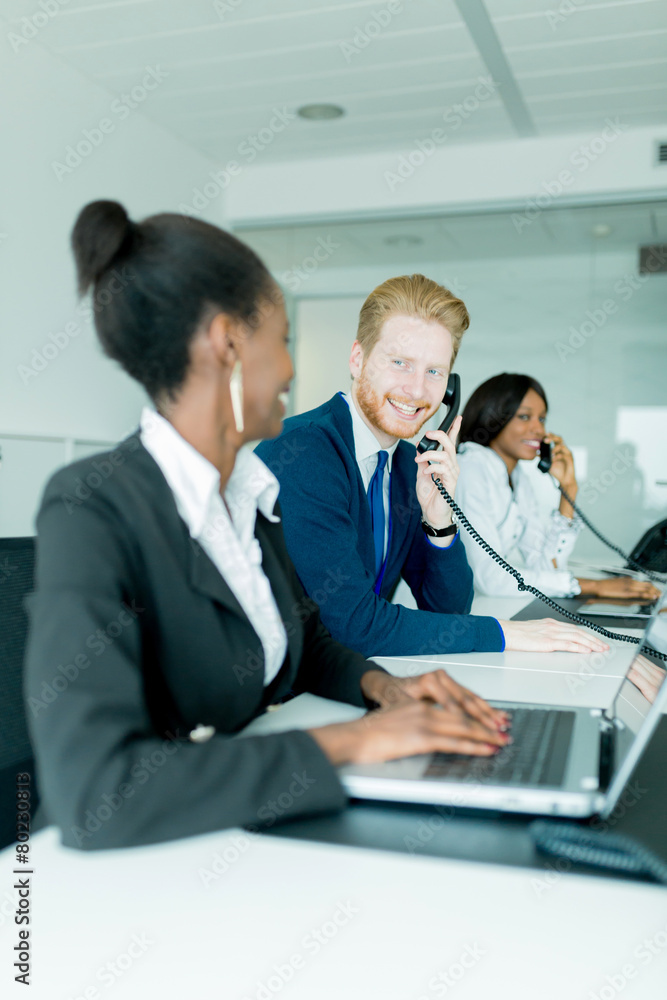 A beautiful, black, young woman working at a call center in an o A beautiful, black, young woman working at a call center in an o