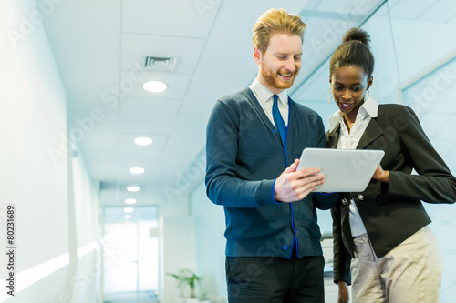 Business partners discussing ideas displayed on a tablet