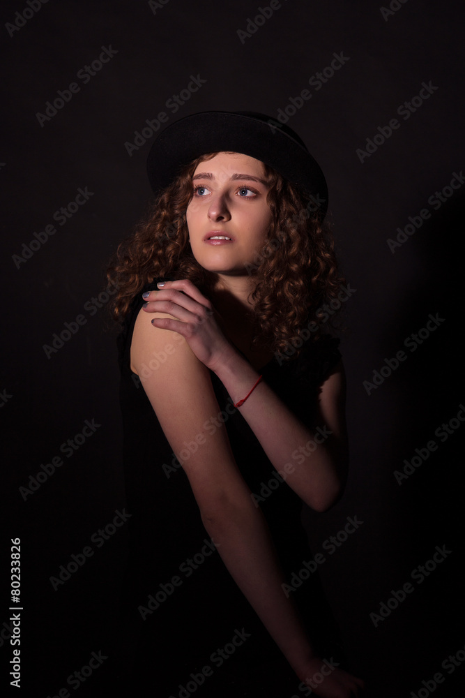 Low key portrait of beautiful girl in black hat Low key portrait of beautiful girl in black hat