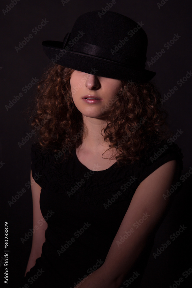 Low key portrait of beautiful girl in black hat Low key portrait of beautiful girl in black hat