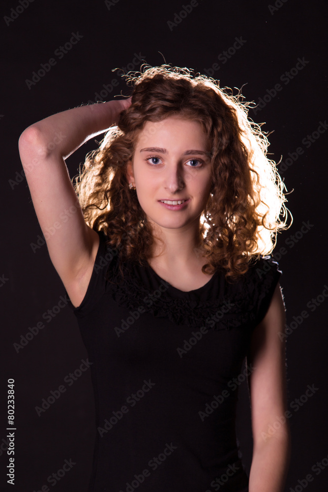 Low key shot of a beautiful smiling young woman Low key shot of a beautiful smiling young woman