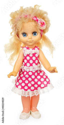 Old plastic doll in pink dress