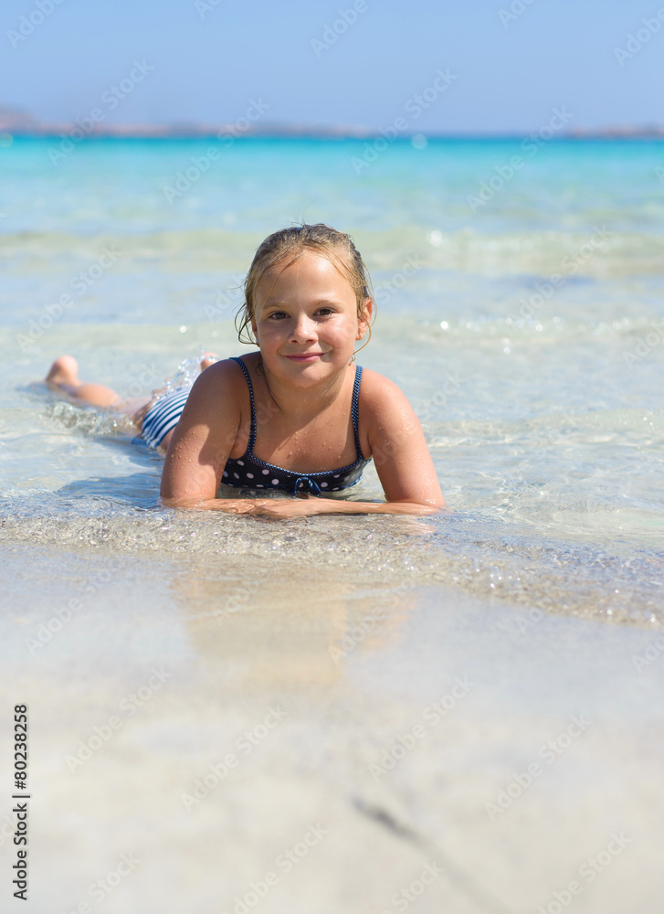 Cute little smiling girl plays at tropical beach Cute little smiling girl plays at tropical beach