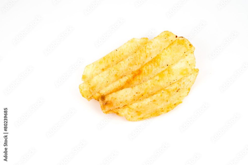 One potato chip on a white background One potato chip on a white background