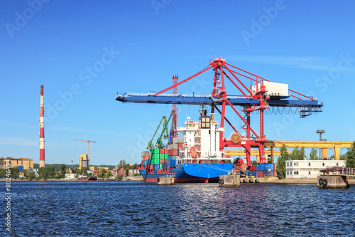 Large container ship in a dock at port of Gdansk  Poland.