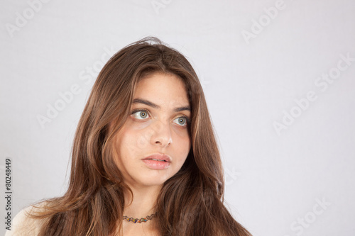 Long haired woman looking thoughtful