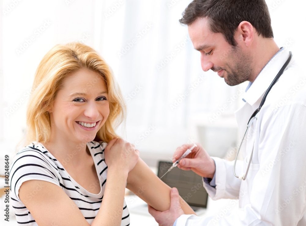 Young attractive woman being vaccinated Young attractive woman being vaccinated