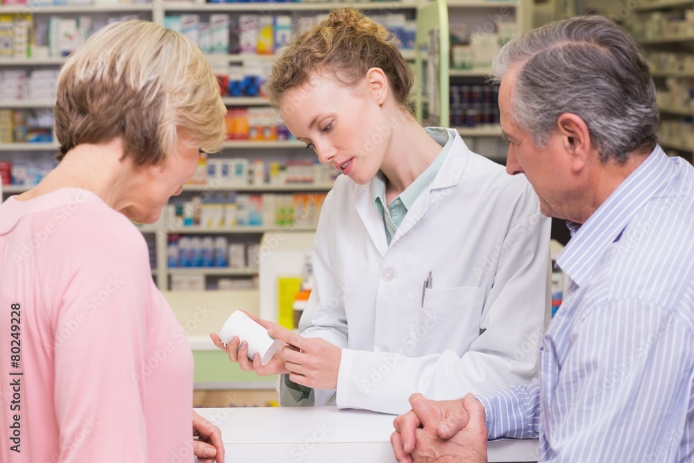 Pharmacist showing medicine jar Pharmacist showing medicine jar
