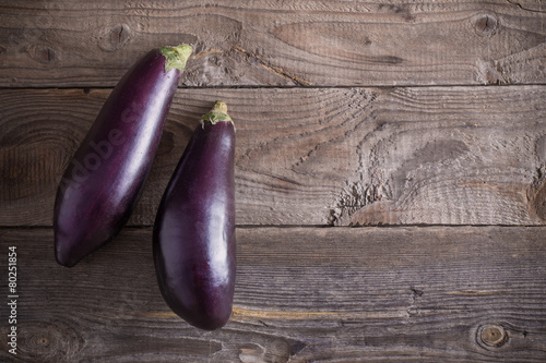 purple eggplants on wooden background