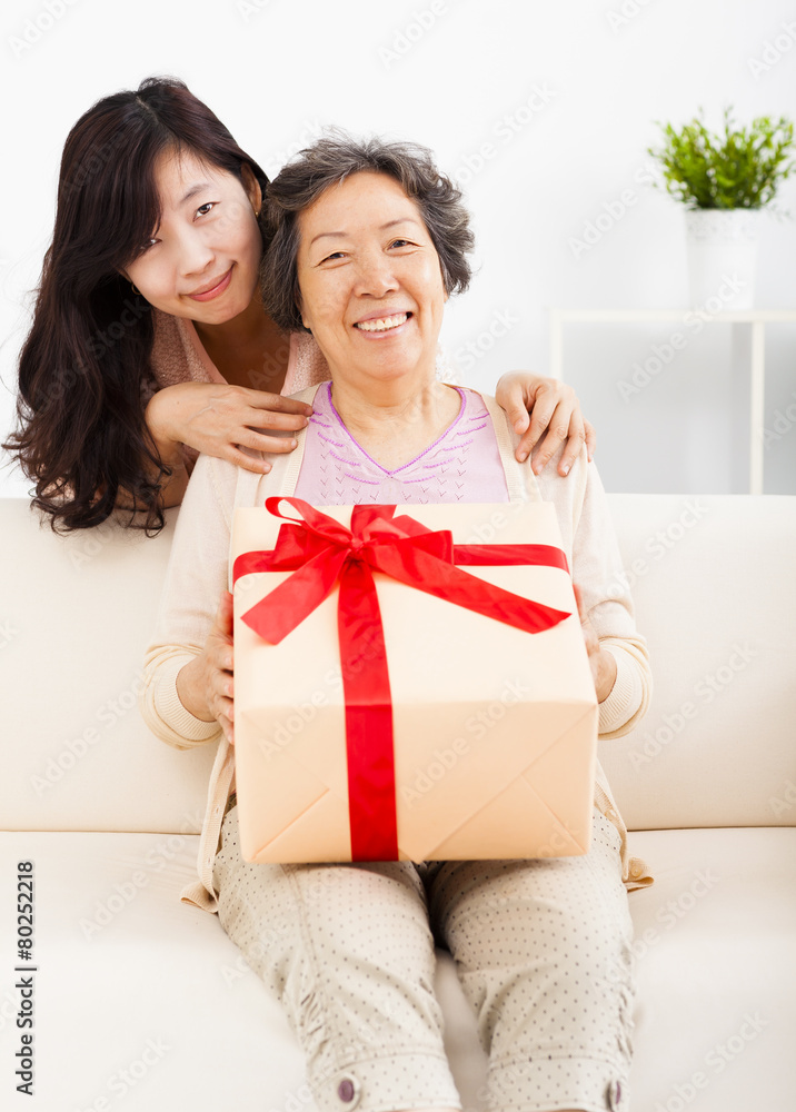 happy mother and daughter with gift box happy mother and daughter with gift box