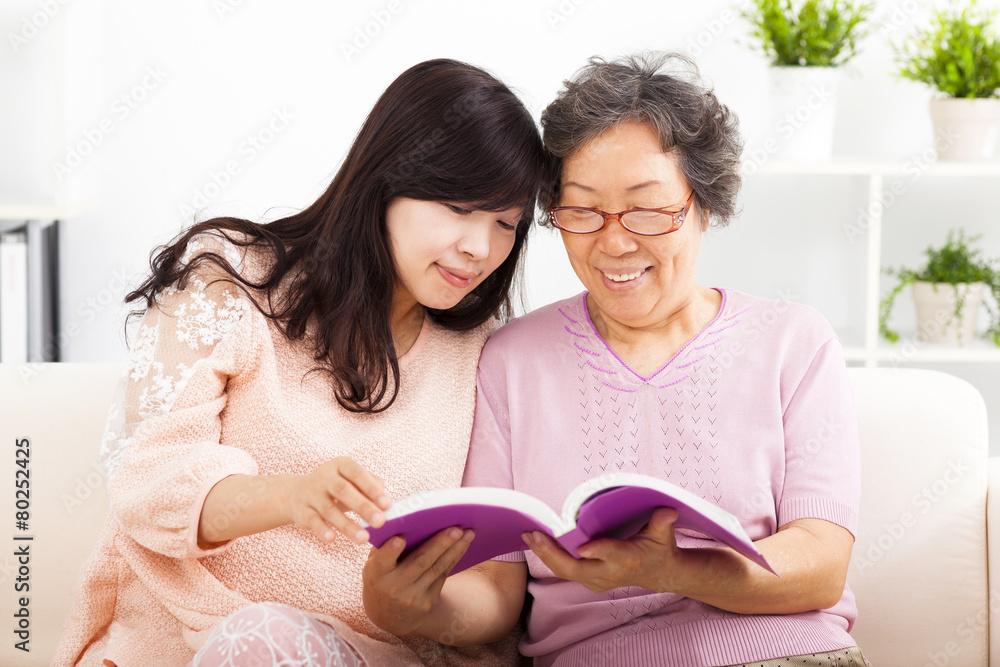 happy mother and her daughter reading book happy mother and her daughter reading book