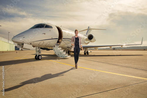 A executive business woman leaving a plane