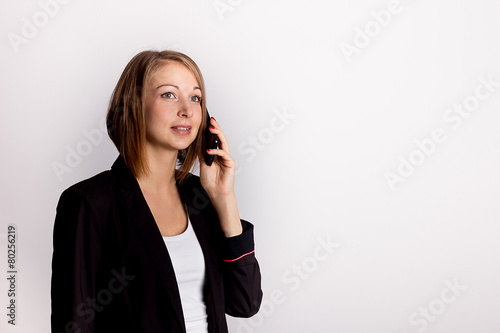 Young businesswoman holding phone surprise