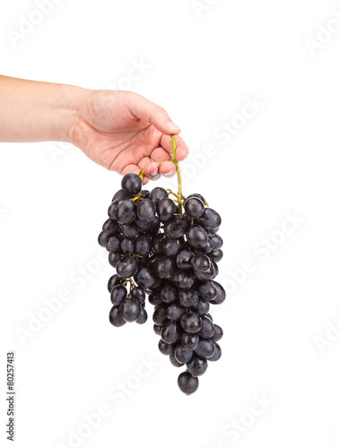 Hand holding red grape