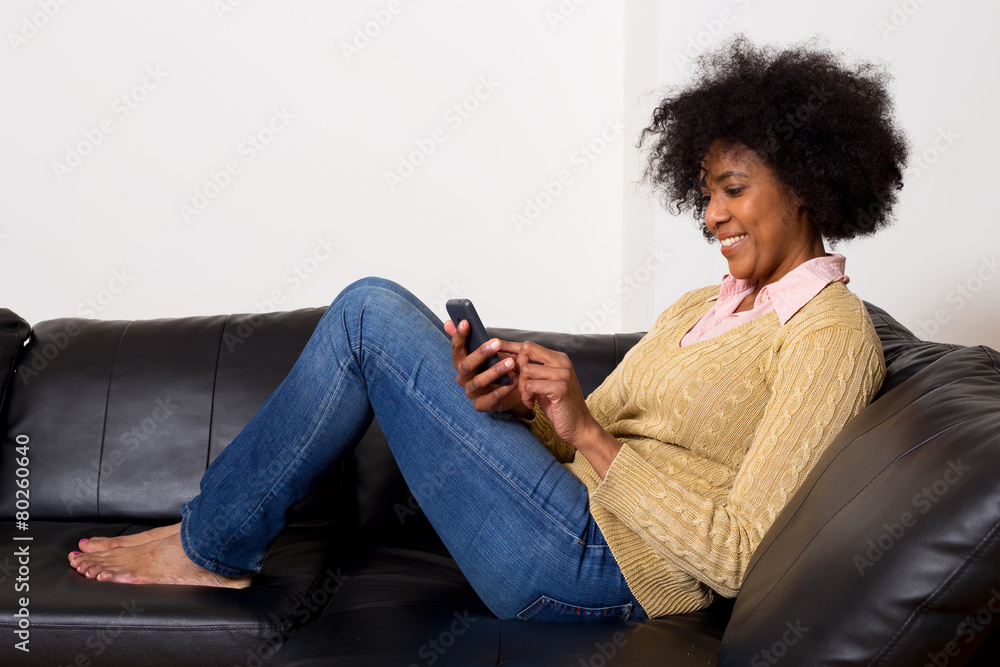 young woman reading her text messages at home young woman reading her text messages at home