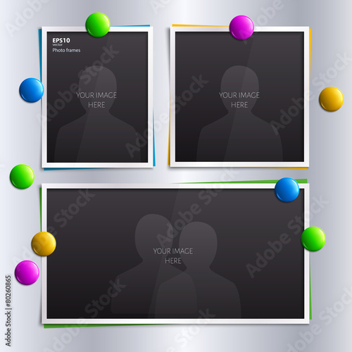 Set of empty photo frames with colorful magnets on the fridge.