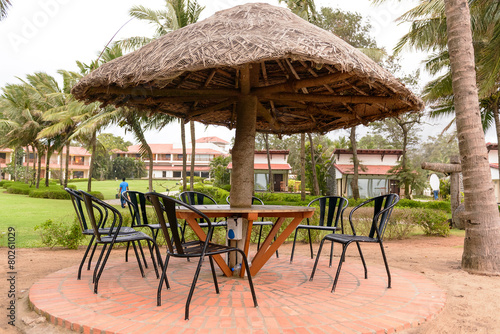 Fototapeta Naklejka Na Ścianę i Meble -  Tropical restaurant with straw sunshade umbrella