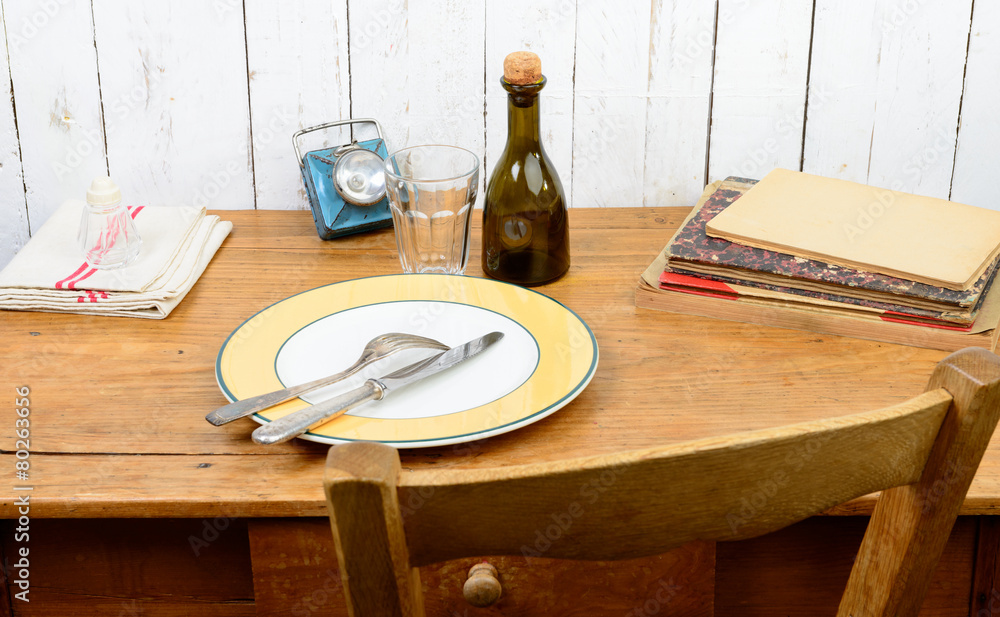 plate and cutlery on an old wooden table