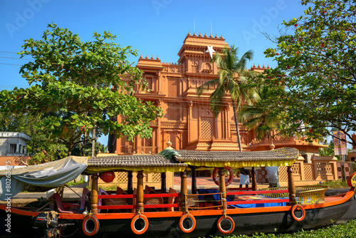 Traditional Indian boat with historic building at background in