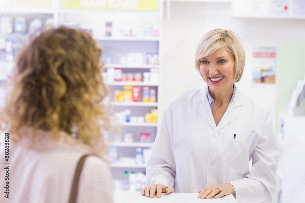 Pharmacist smiling at costumer