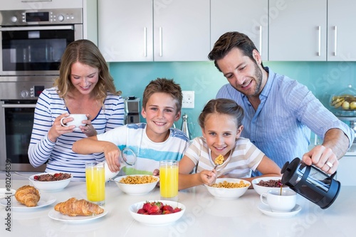 Happy family having breakfast together