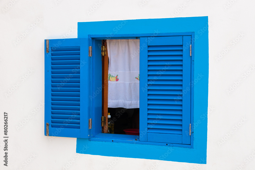 Blue window of a typical white house, Madeira island, Portugal