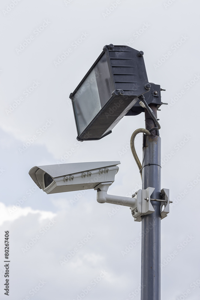 Surveillance camera and lighting on plain pole Surveillance camera and lighting on plain pole