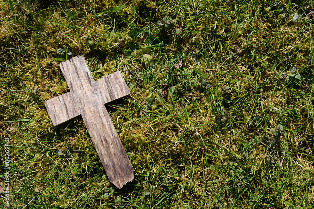 Small cross on grass and moss Small cross on grass and moss
