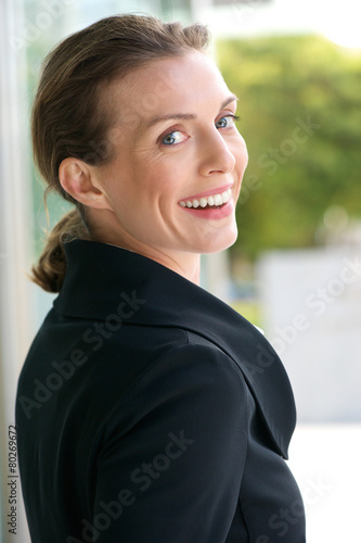 Beautiful business woman smiling outside