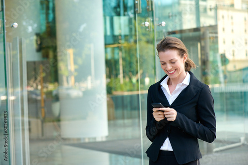 Free Download Happy business woman reading text message on mobile phone - GFXLoad