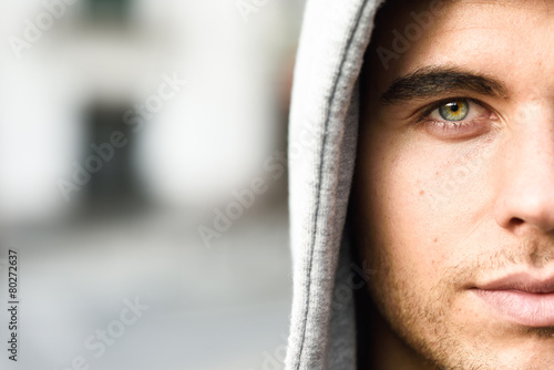 Handsome young man with blue eyes in urban background