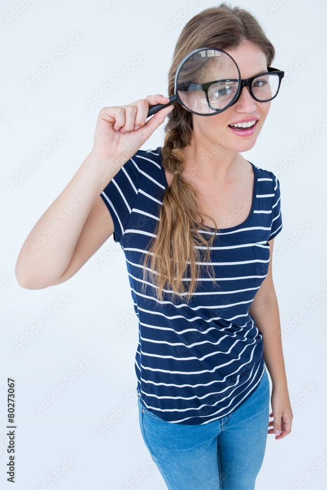 Smiling woman holding magnifying glass Smiling woman holding magnifying glass