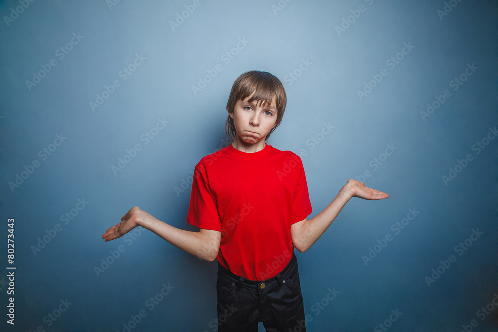 boy, teenager, twelve years in the red shirt spread his hands, t boy, teenager, twelve years in the red shirt spread his hands, t