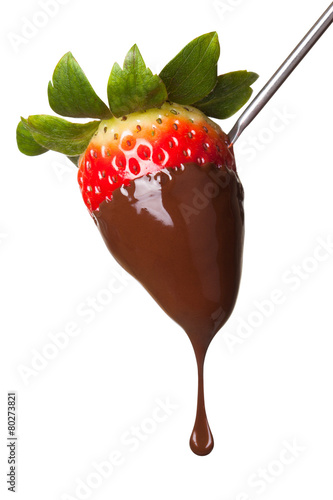 Strawberry dipped in chocolate on fondue skewer.