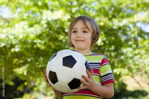 Happy little boy holding football © WavebreakmediaMicro
