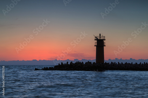 Beautiful seascape with lighthouse at sunrise