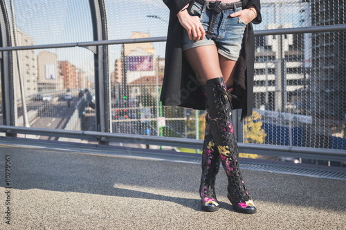 Detail of a beautiful young brunette posing on a bridge