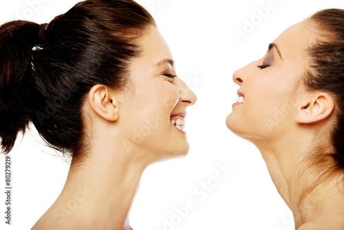Two laughing women with make up.