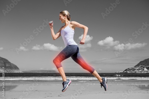 Fototapeta Naklejka Na Ścianę i Meble -  Highlighted leg of jogging woman on beach