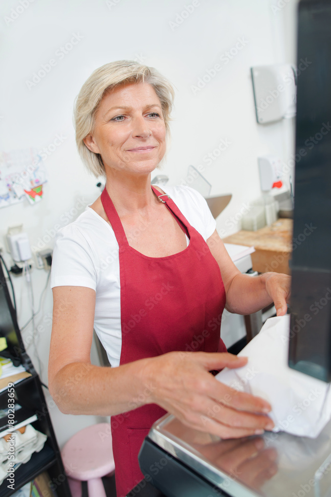 Customer paying at the butcher shop Customer paying at the butcher shop