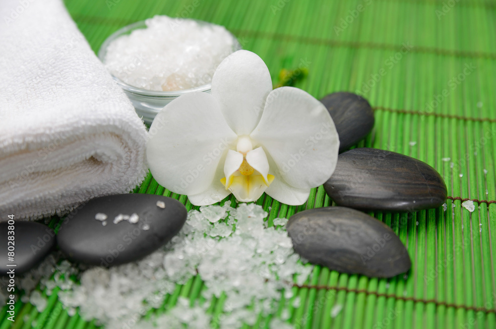 Spa setting with orchid ,stones ,towel ,many salt Spa setting with orchid ,stones ,towel ,many salt