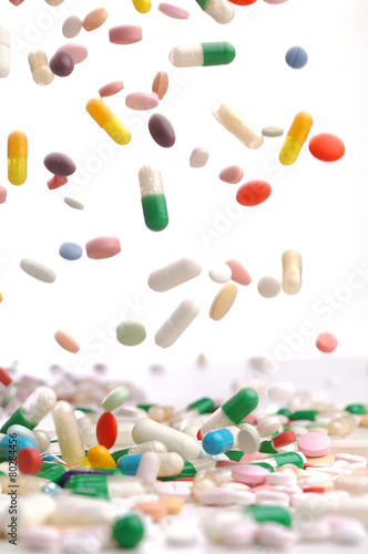 colorful medicine pills falling.