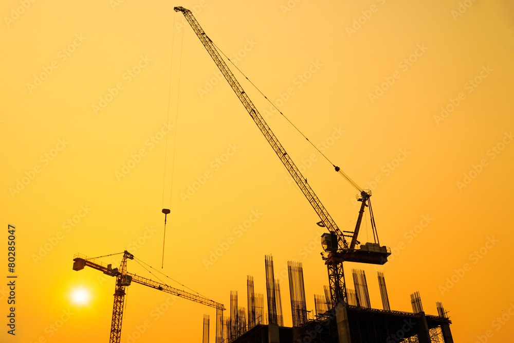 Construction site with cranes on silhouette background
