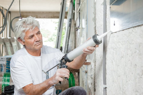 Caulking a window frame photo