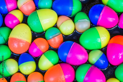 Colorful plastic eggs toys floating on the water background