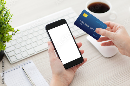 female hands holding phone with isolated screen and credit card