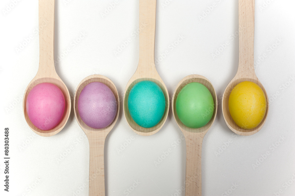 easter eggs in wooden spoons isolated on white easter eggs in wooden spoons isolated on white