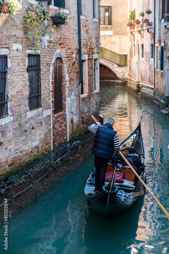 Venice canal with gondola, Italy photo