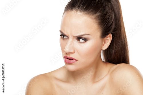 angry beautiful woman looking aside on a white background