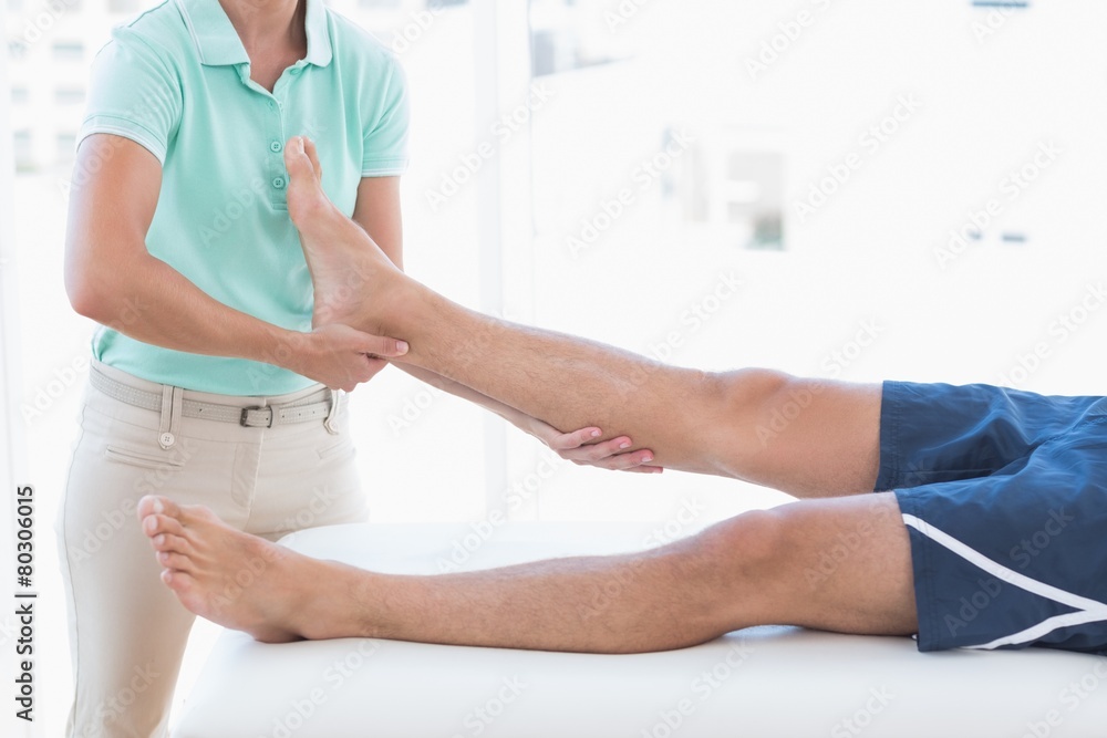 Doctor examining man leg Doctor examining man leg